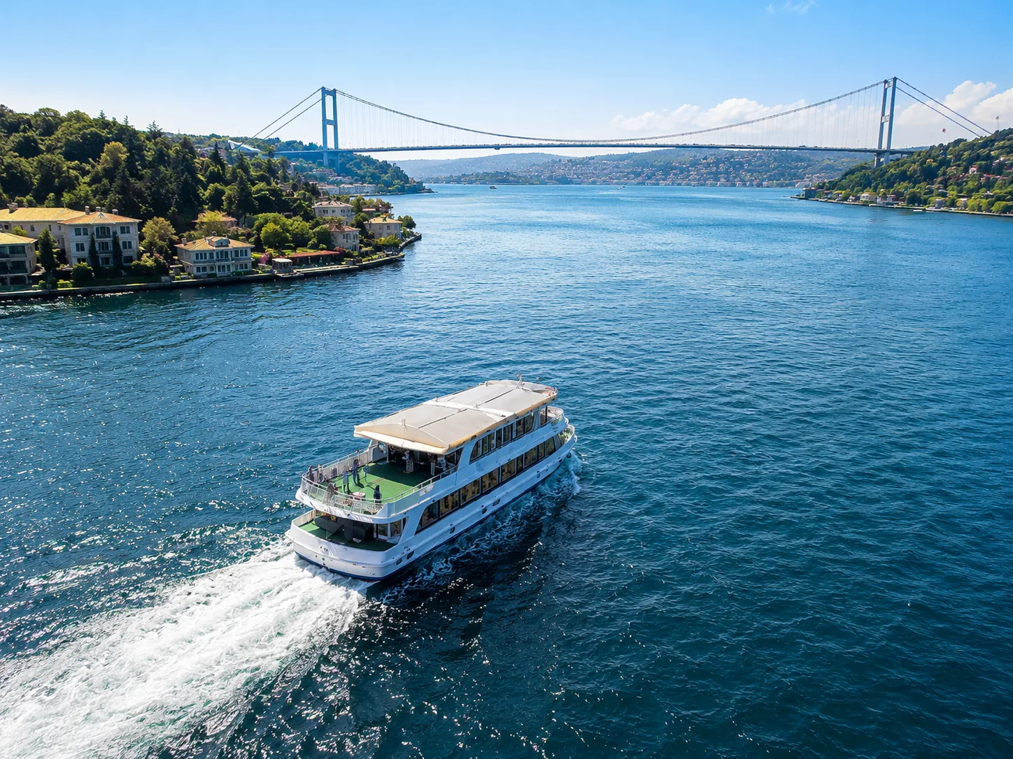 The Sezgün Tur boat cruising the bright blue Bosphorus