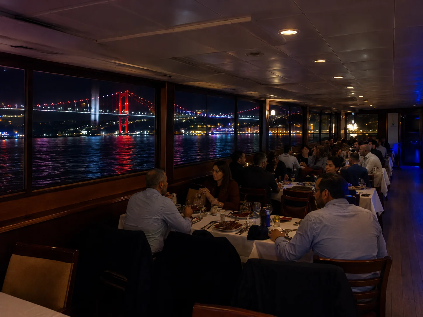 Dinner aboard at night with the lit bridge